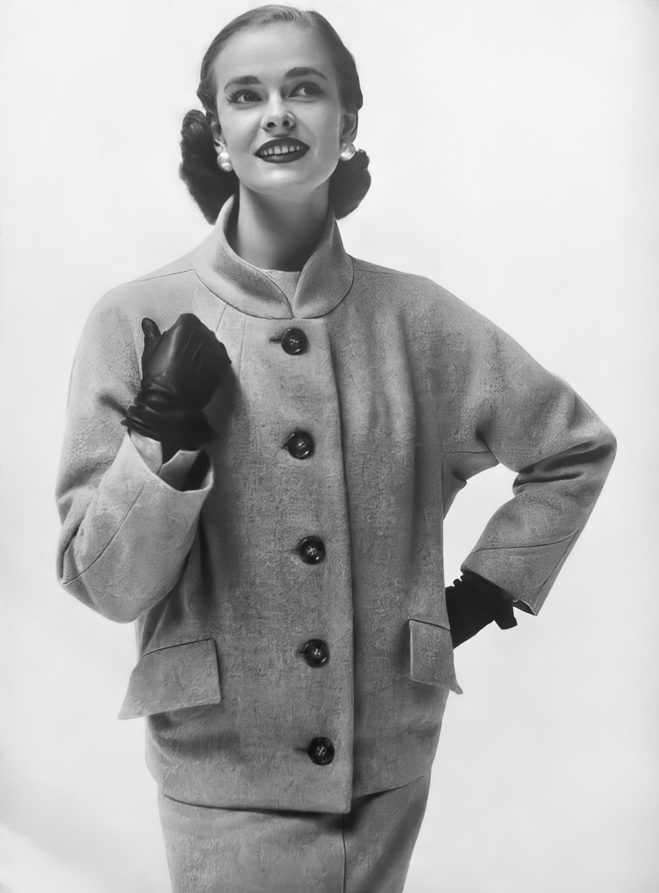 Susan Abraham in a smoke-gray jacket with a stand-away collar, 1953.