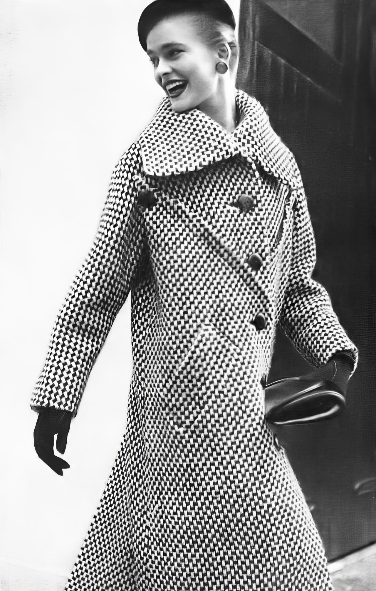 Susan Abraham in a bold black and white basket-tweed coat, 1953.