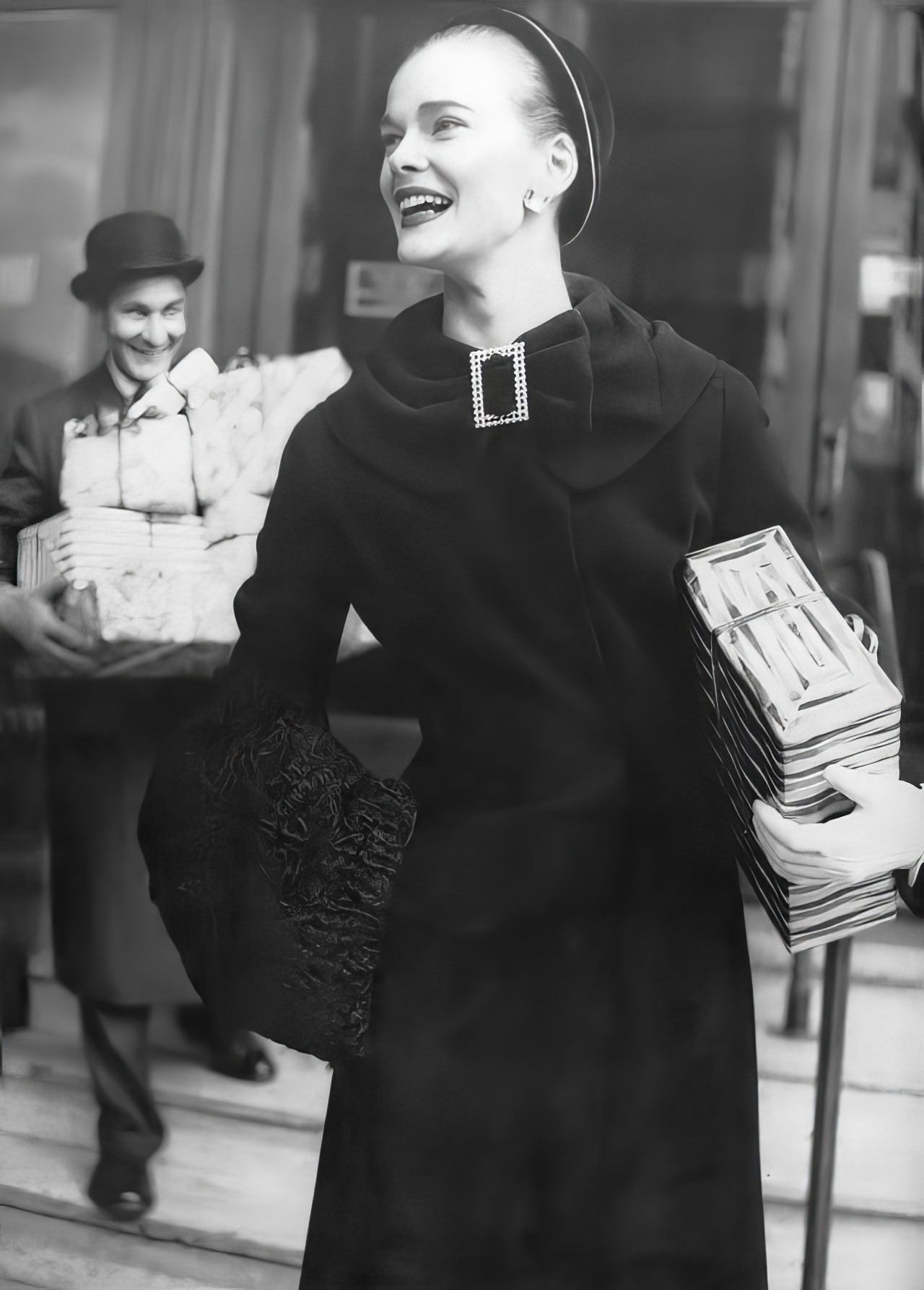 Susan Abraham in a fitted coat of black worsted duvetyne, 1954.