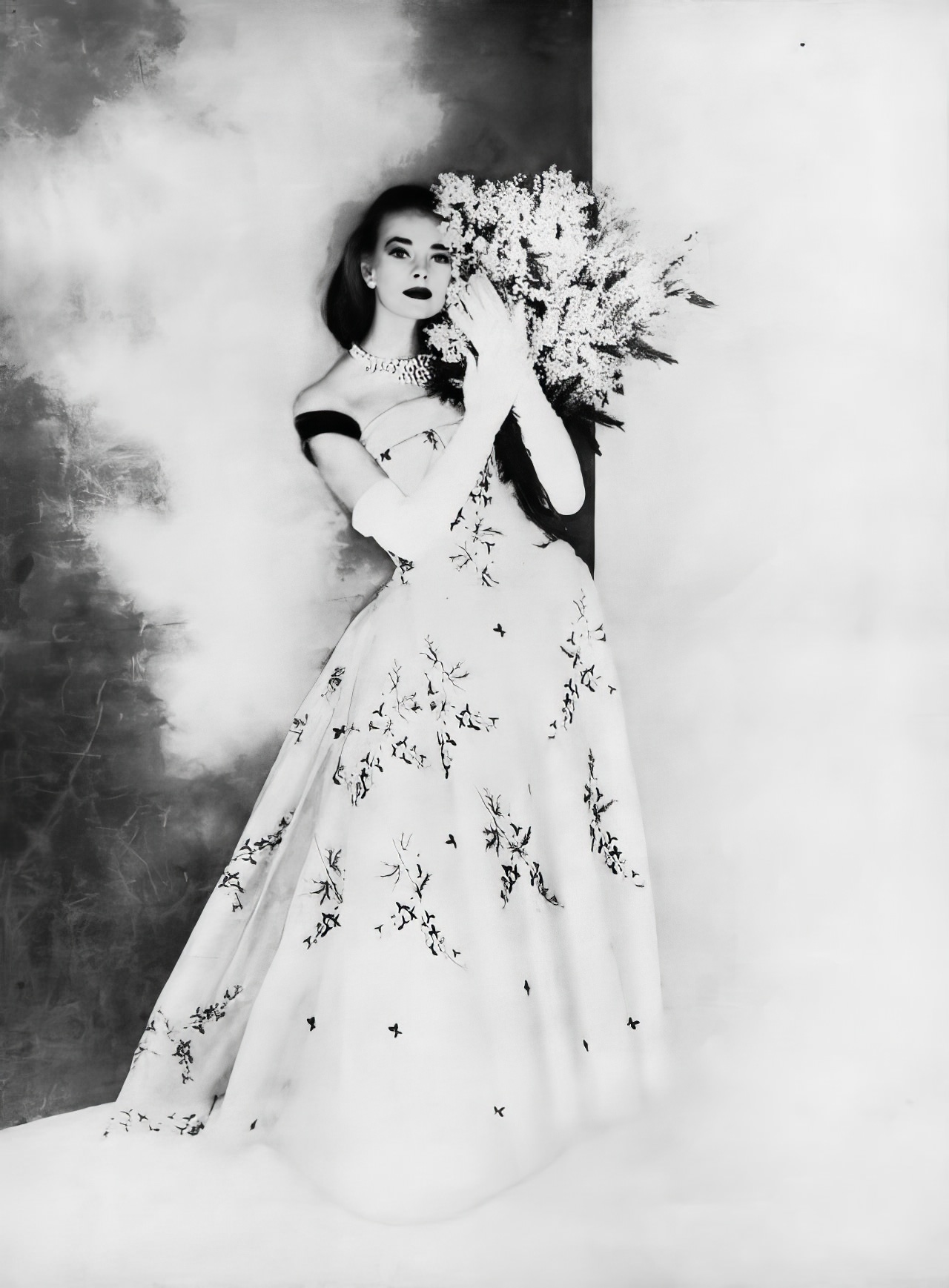 Susan Abraham in a beautiful ball gown of bluebells embroidered on white silk organdie, 1956.