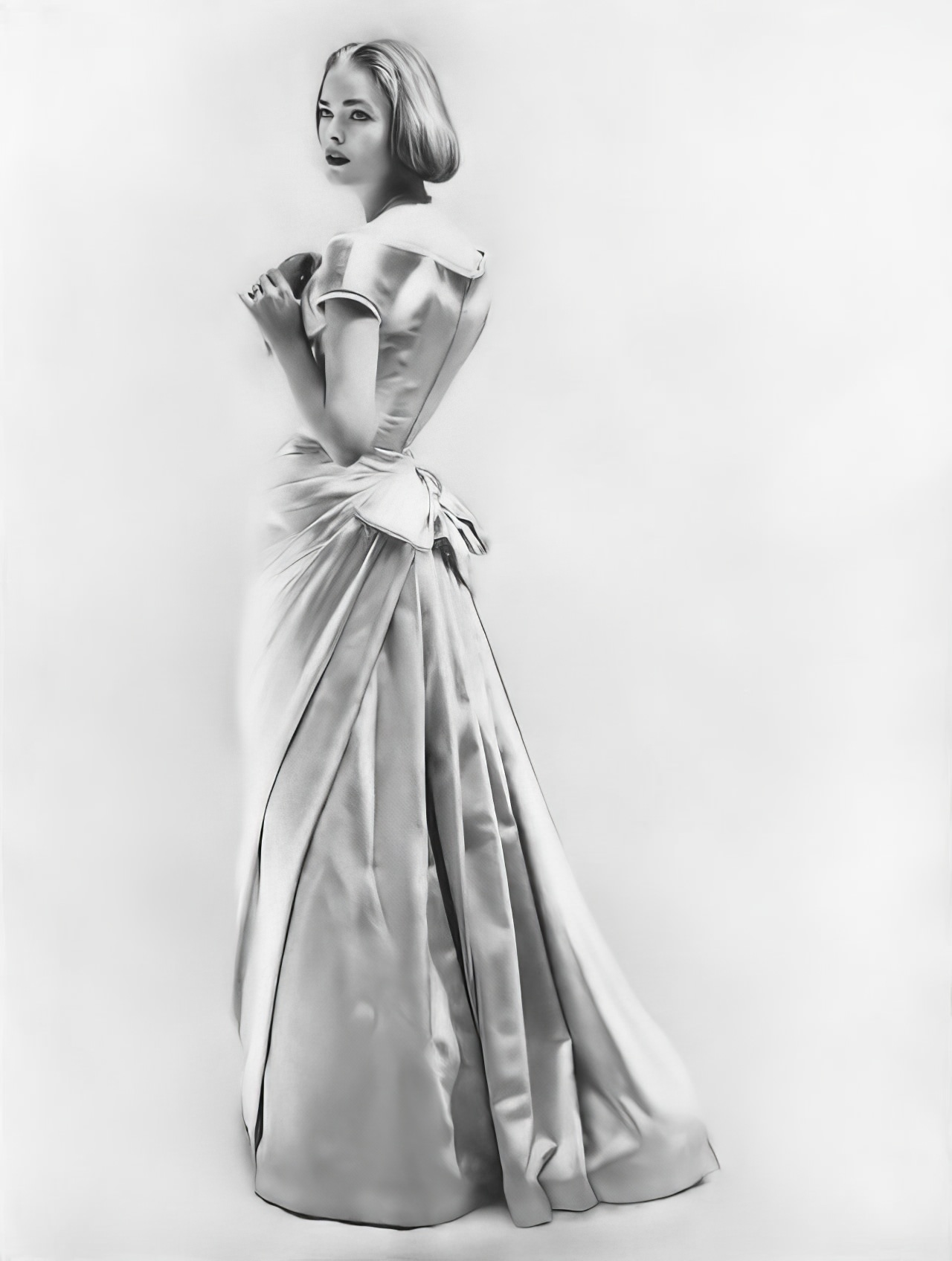 Susan Abraham in an evening dress of eglantine satin, 1956.