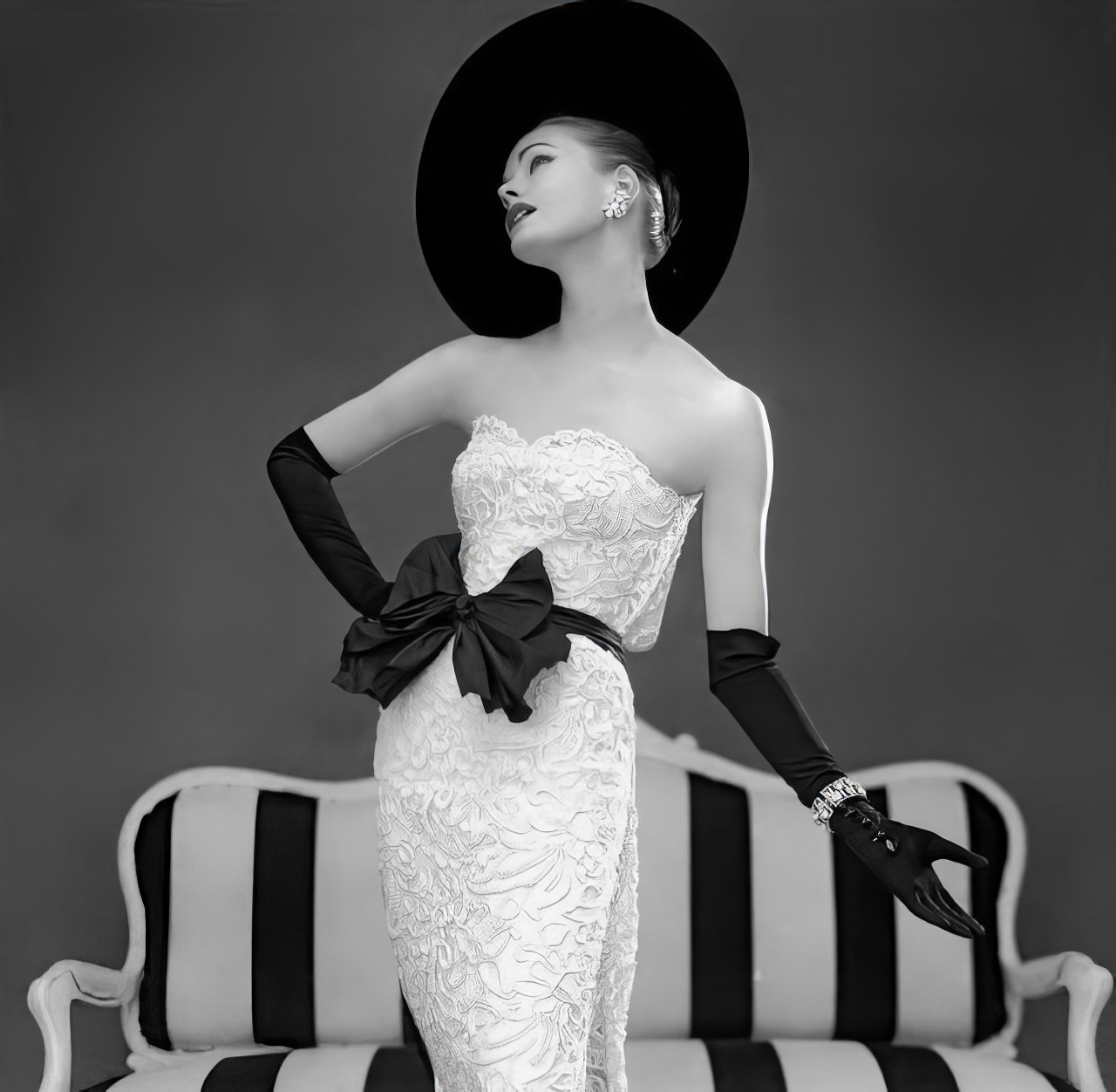 Susan Abraham in John Cavanagh's strapless evening gown, 1957.