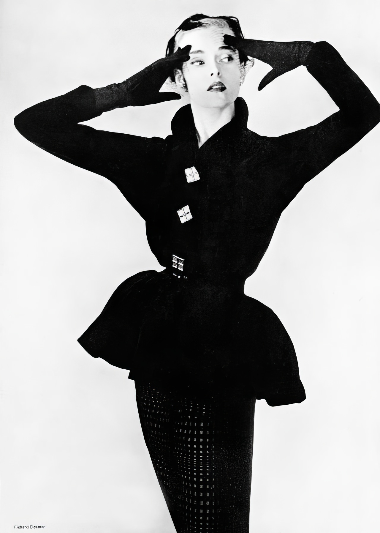 Susan Abraham in a cocktail suit with a lampshade jacket and self-checked black velvet skirt, 1951.