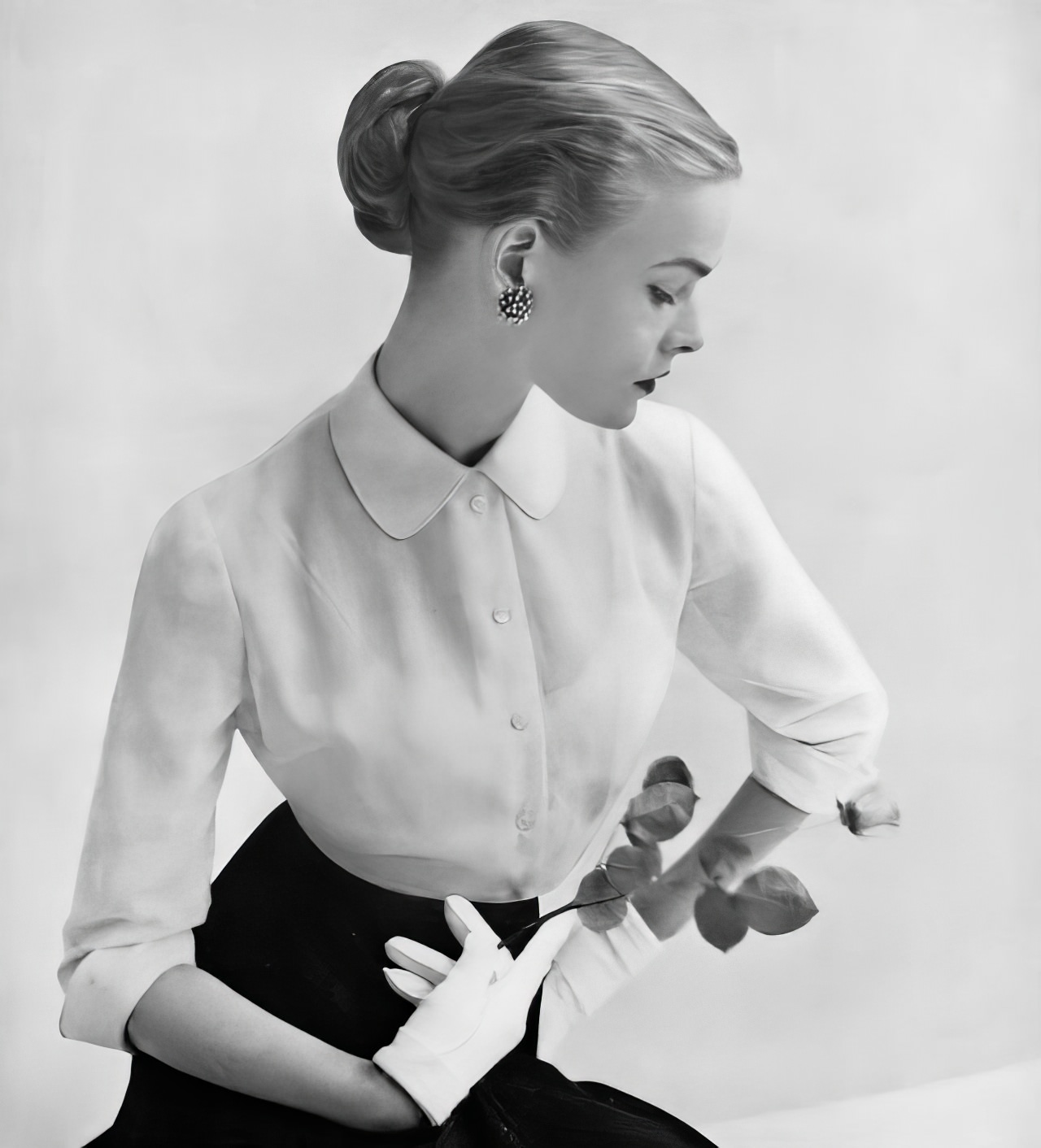 Susan Abraham in a Swiss voile blouse with a stiff collar and fly-away cuffs, 1951.