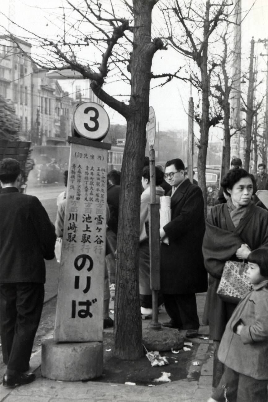 A bus stop in Tokyo, 1950s.