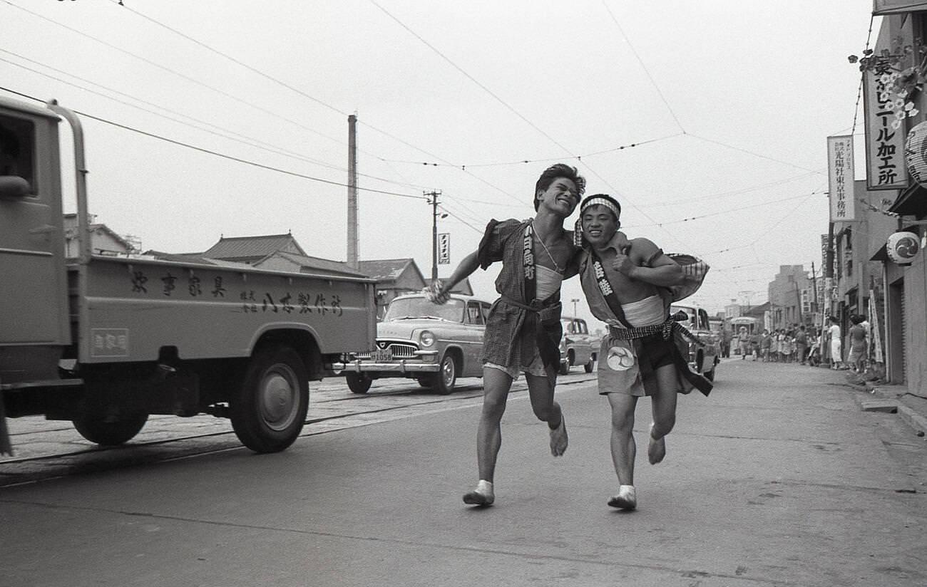 Two young men in happy coats at a matsuri in Tengenji, Tokyo, 1958.