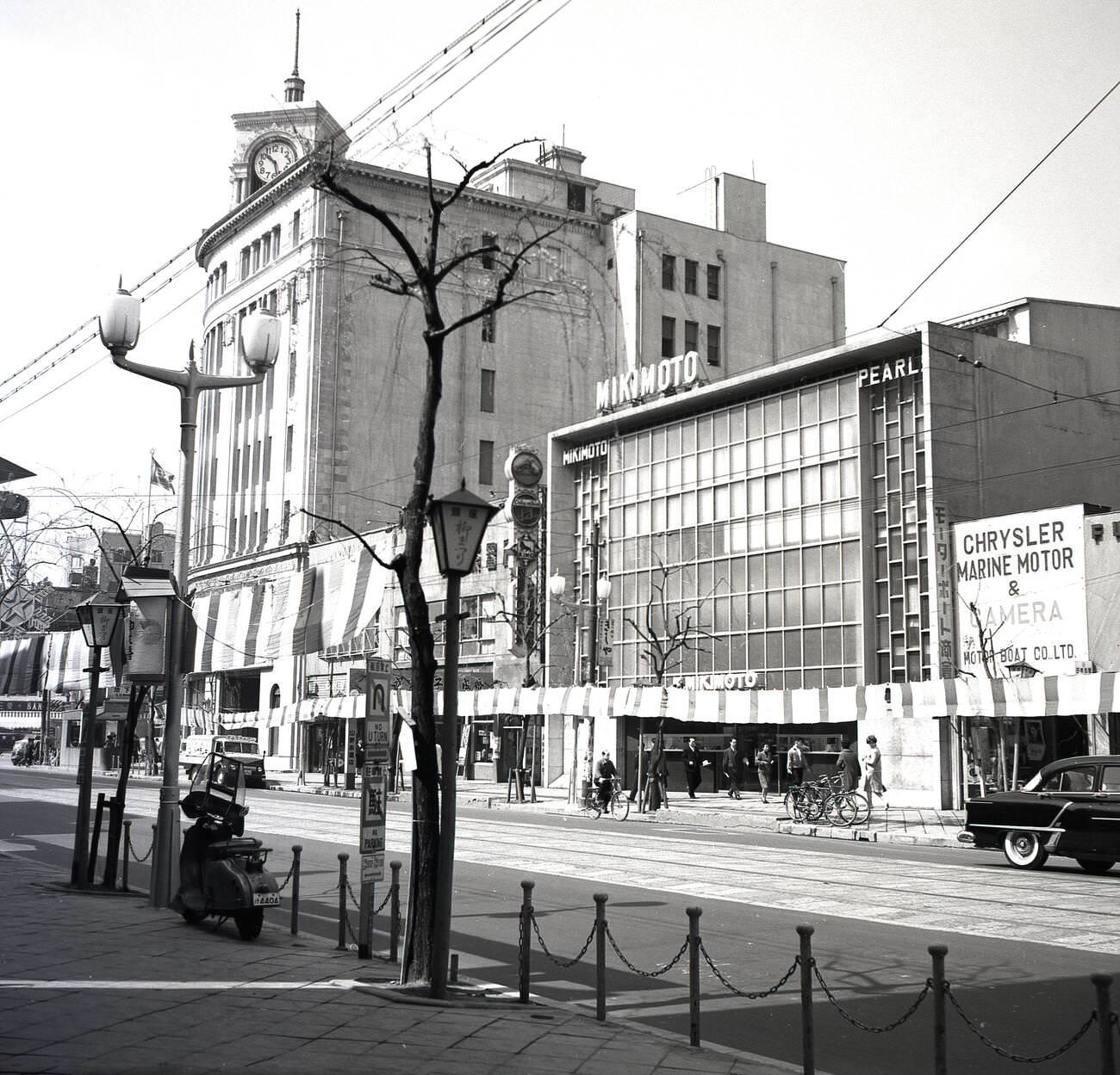 A street in the city of Tokyo showing the offices of the famous Mikimoto pearl company, 1950s.
