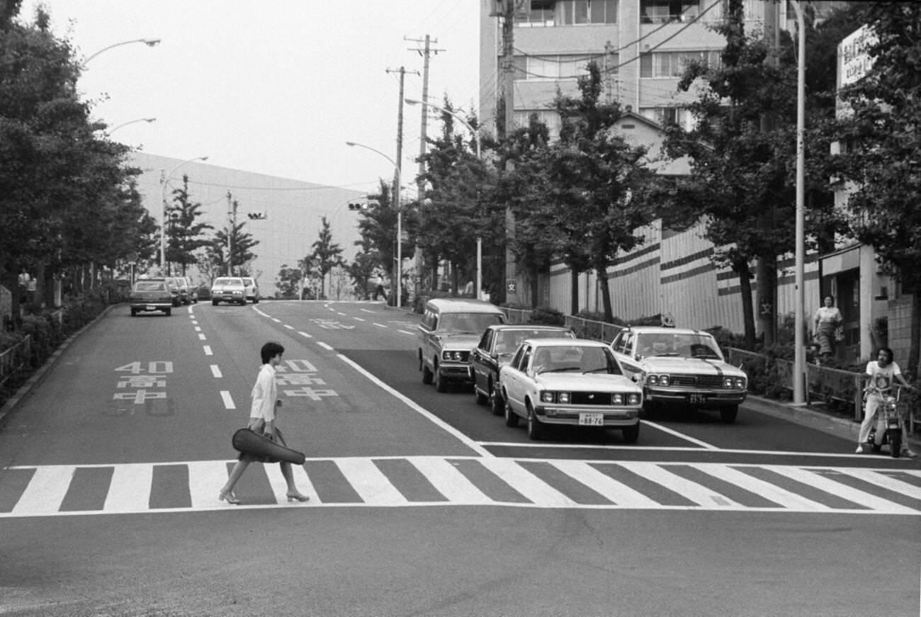 A woman crosses the street, Tokyo, 1979.