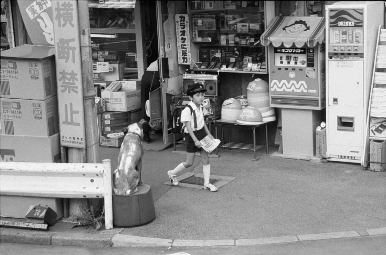 A child with a newspaper in his hand, Tokyo, 1979.