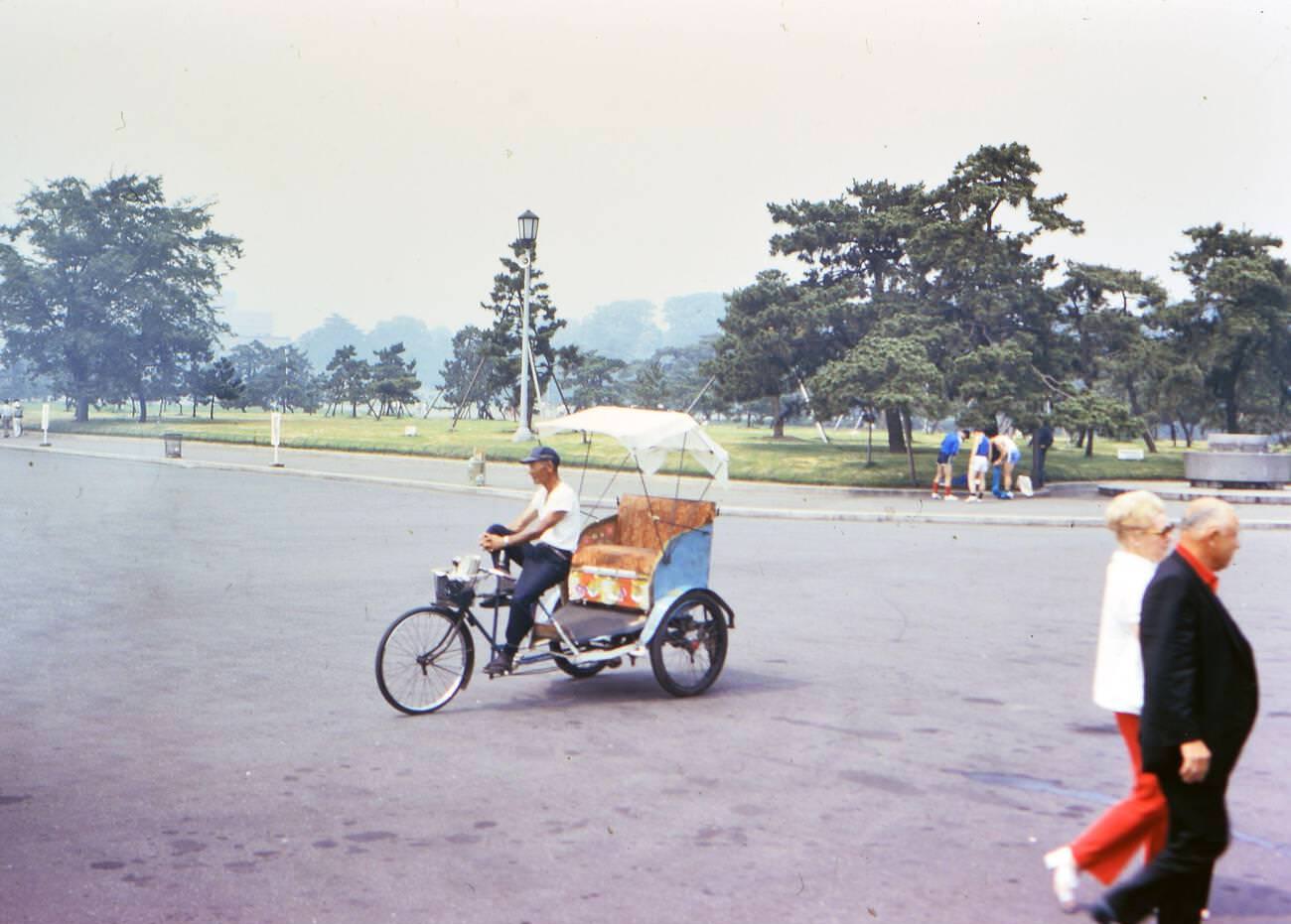 A man sitting in his rickshaw, waiting for a customer, Tokyo, 1973.