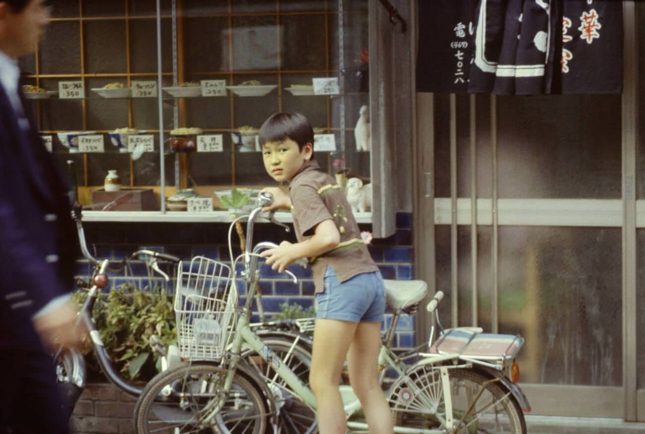 Child with a bicycle, Tokyo, 1970s.