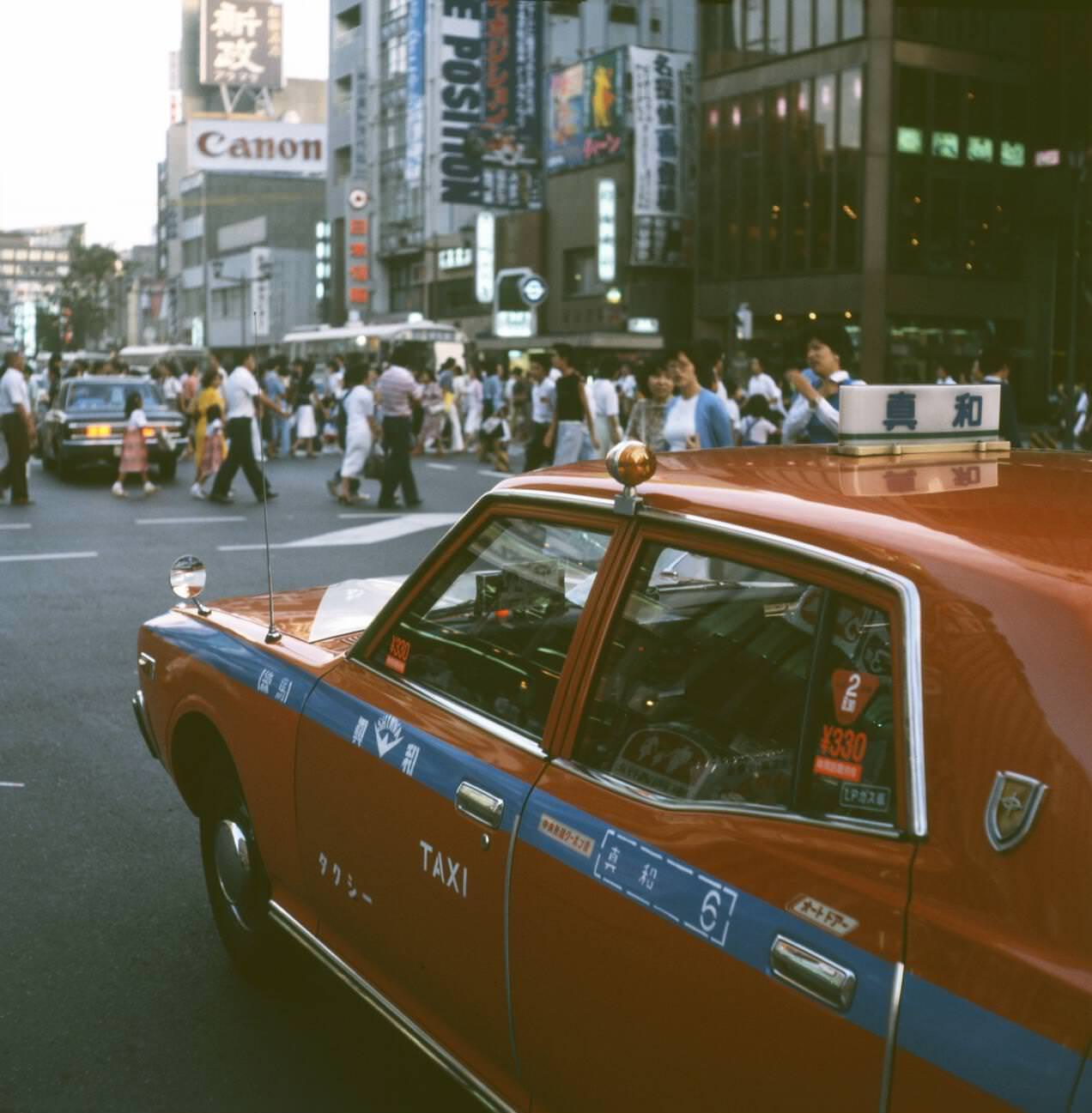 Red taxi on the street in Tokyo, 1970s.