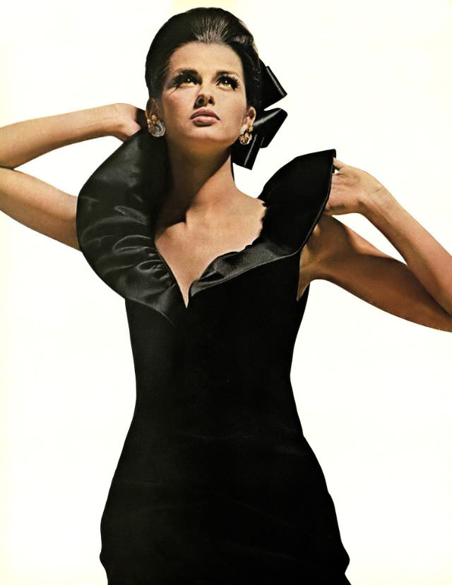 Veronica Hamel in a black crepe cocktail dress with the Queen Anne collar, 1964.