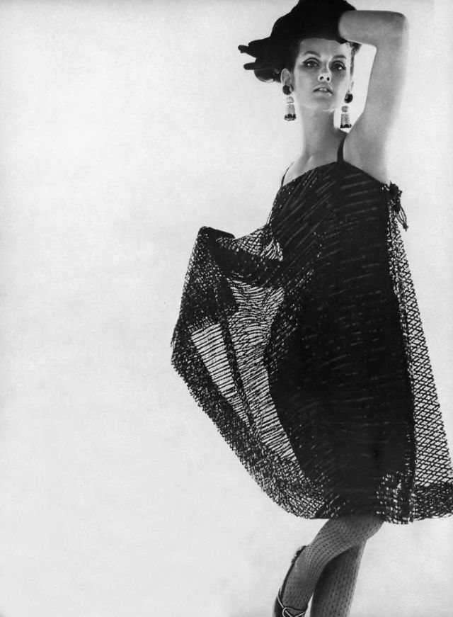 Veronica Hamel in a black cage dress of lace covered with sequins, 1964.