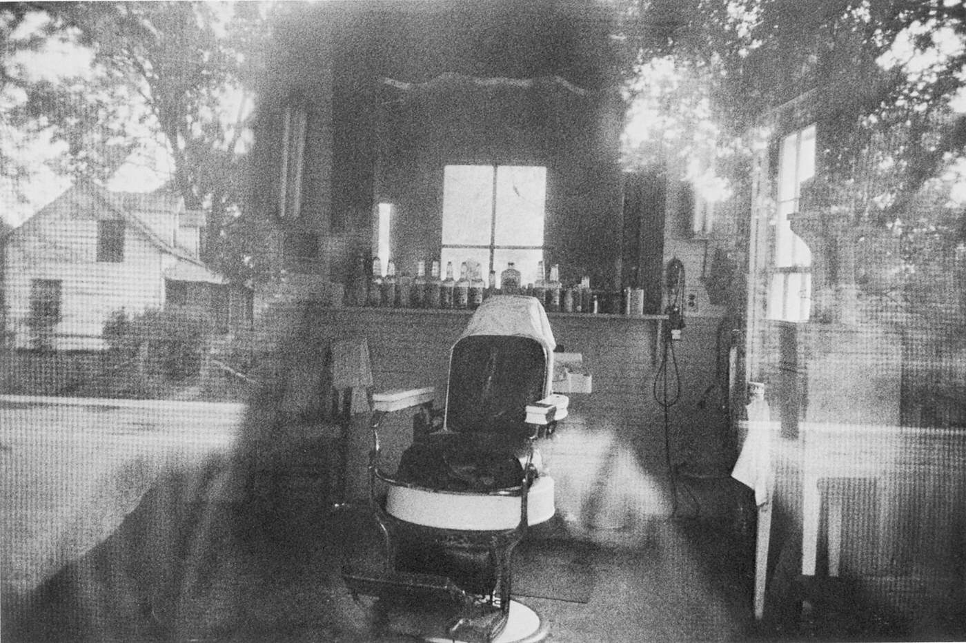 Barber shop through screen door — McClellanville, South Carolina, 1956