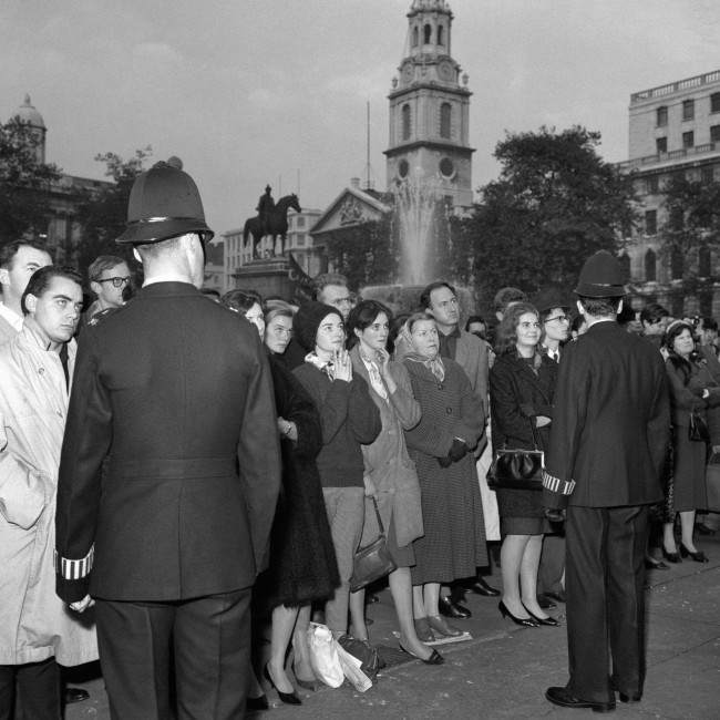 Police keep a respectful presence at the protest meeting in Trafalgar Square organised by The Committee of 100. The crowd are listening intently as one of the founders of the movement, the philosopher Earl Russell, was speaking, 1961.