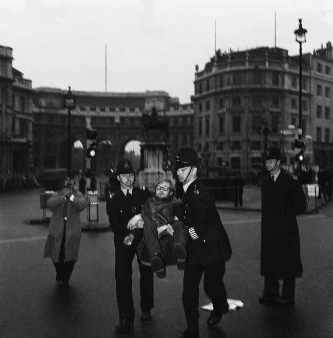 A demonstrator lets himself go limp as police officers carry him from Trafalgar Square, London, United Kingdom, to a waiting van during the mass ban-the-bomb rally, 1961.