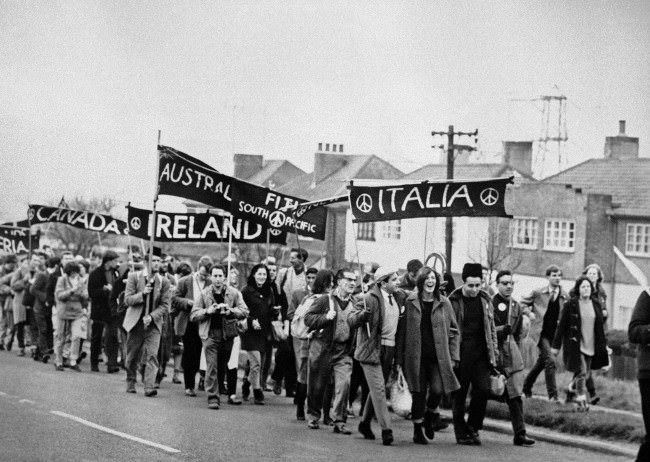 Foreign groups (from Italy, Fiji, Australia, Canada, and Algeria) are in the column of marchers as some 10,000 supporters of the Campaign for Nuclear Disarmament set out from Reading, Berkshire, on the second leg of their protest march from Aldermaston to London, 1962.