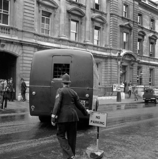 "Ban-the-Bomb" is written in the dust on the back of the Metropolitan Police Black Maria van, believed to be carrying members of the the anti-nuclear Committee of 100 after they had received jail sentences at Bow Street Magistrates court, 1961.