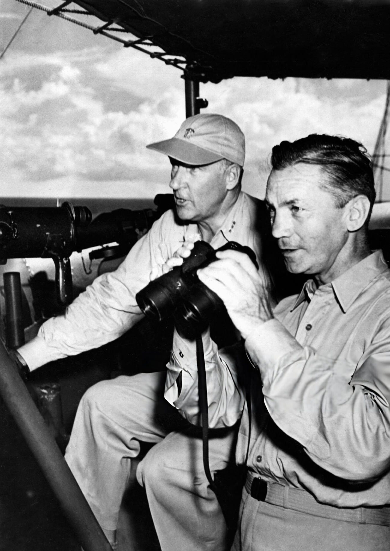 Secretary of the U.S. Navy, James Forrestal (right), and Vice Admiral W.H.P. Blandy (left), commander of the joint Army-Navy Task Force 1, watch the atom bomb explode over Bikini Lagoon, 1946.