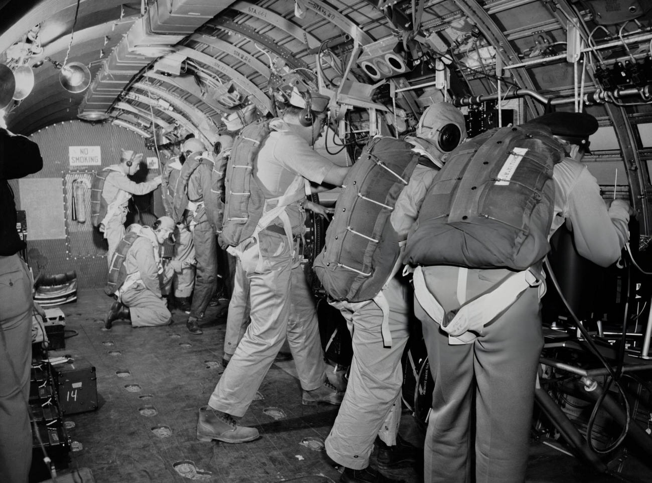 Eight photographers with their cameras in a demonstration in a converted C-54 aircraft, at Roswell Army Air Field in Roswell, New Mexico, 1946.