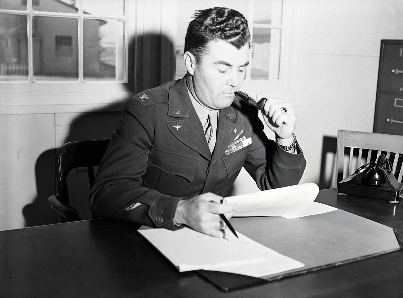 Col. Paul W. Tibbets of Orlando, Fla., is shown in his office at Roswell Field where preliminary preparations are being made for the gigantic atomic bomb test scheduled for Bikini Atoll this summer, 1946.