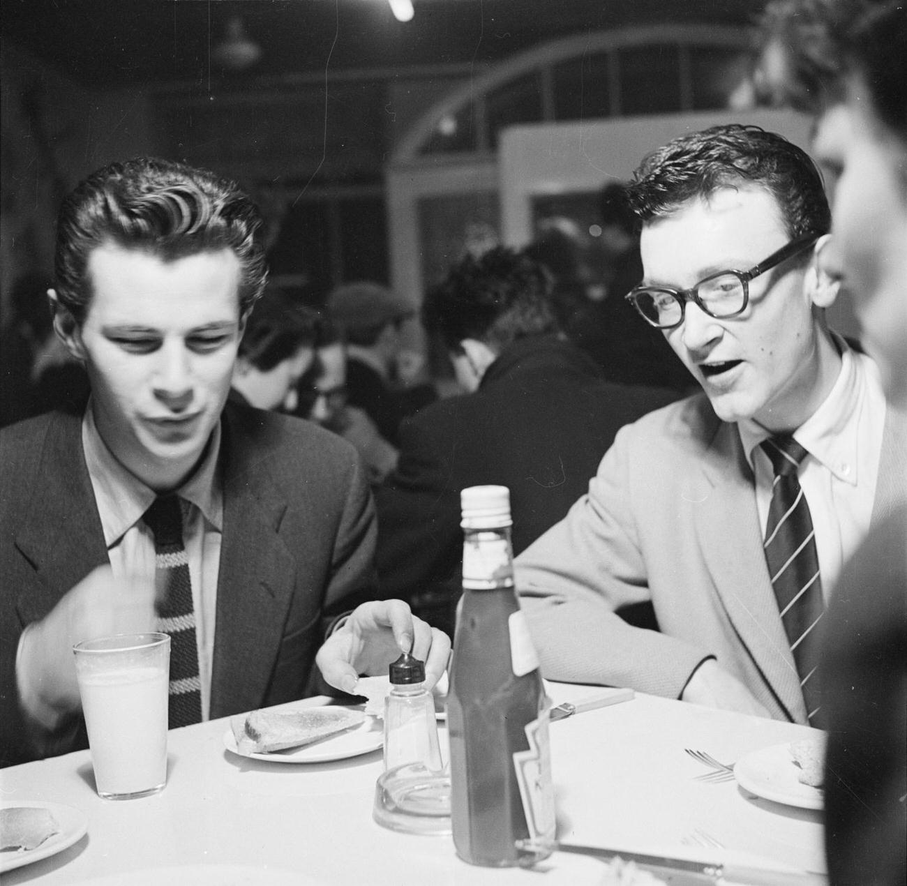 Photograph of jazz musicians at a table at the Harmony Inn on Archer Street including the saxophonist Derek Humble by Nigel Henderson.1954