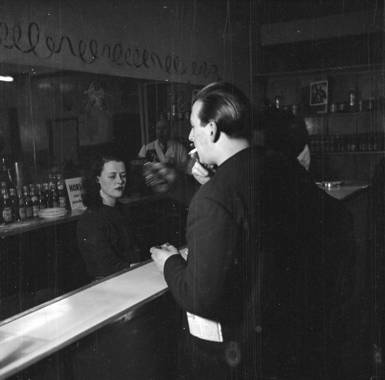 A man at a bar by Nigel Henderson c.1954Photograph of jazz musicians playing table football, including Tony Crombie and Derek Humble Nigel Henderson 1917-1985 The papers were acquired by the Tate Archive from Janet Henderson and the Henderson family in 1992.