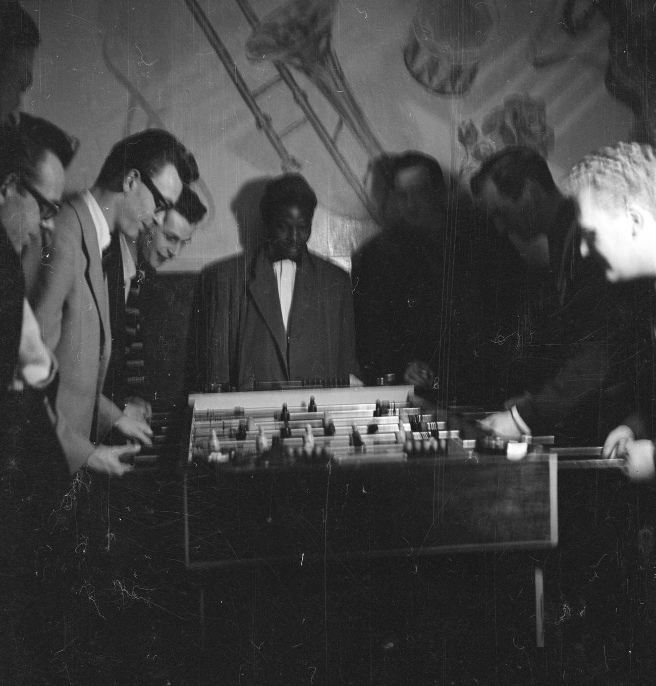 A man at a bar by Nigel Henderson c.1954Photograph of jazz musicians playing table football, including Tony Crombie and Derek Humble Nigel Henderson 1917-1985