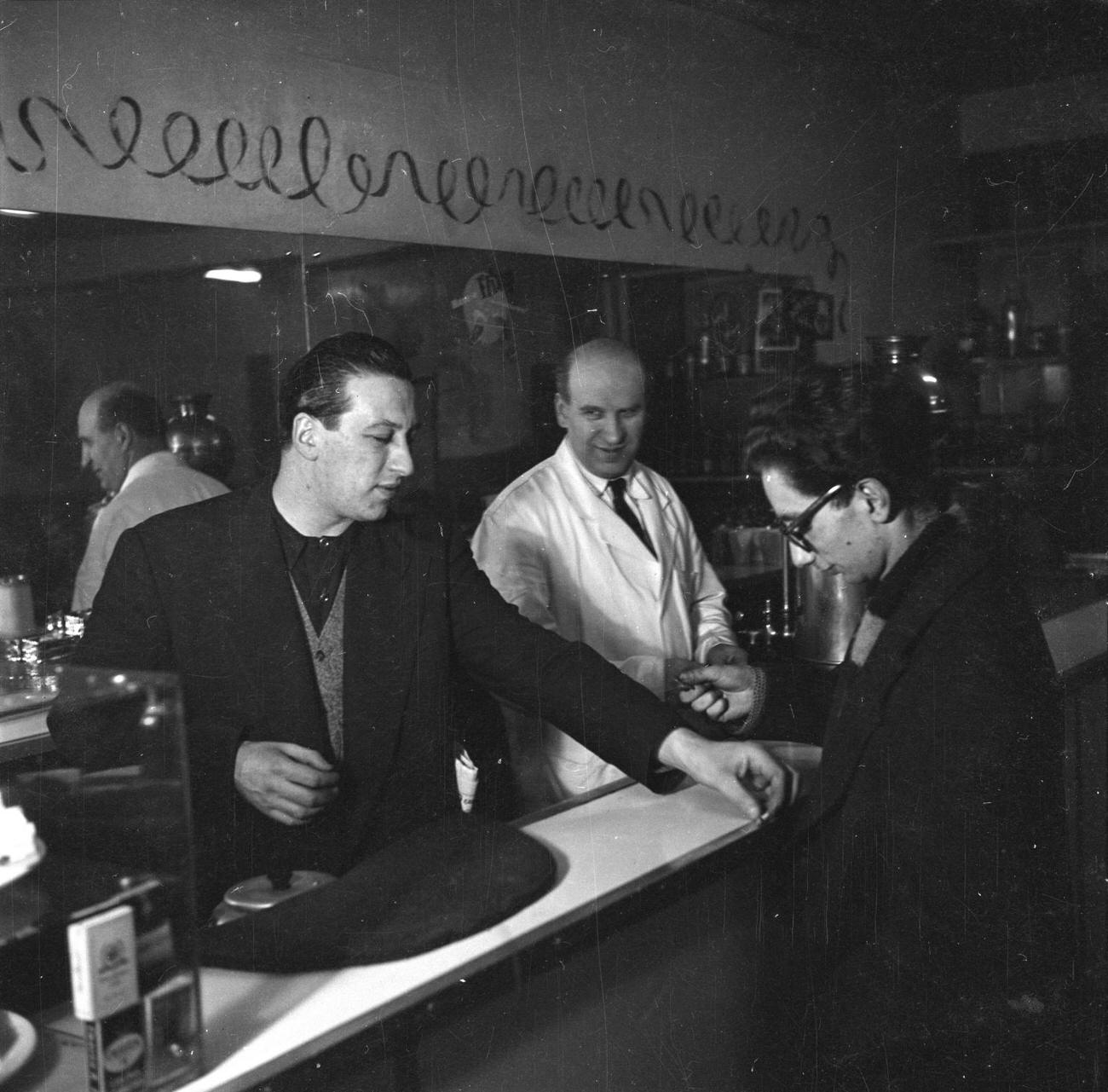 Photograph showing aman at a bar Nigel Henderson 1917-1985 The papers were acquired by the Tate Archive from Janet Henderson and the Henderson family in 1992.