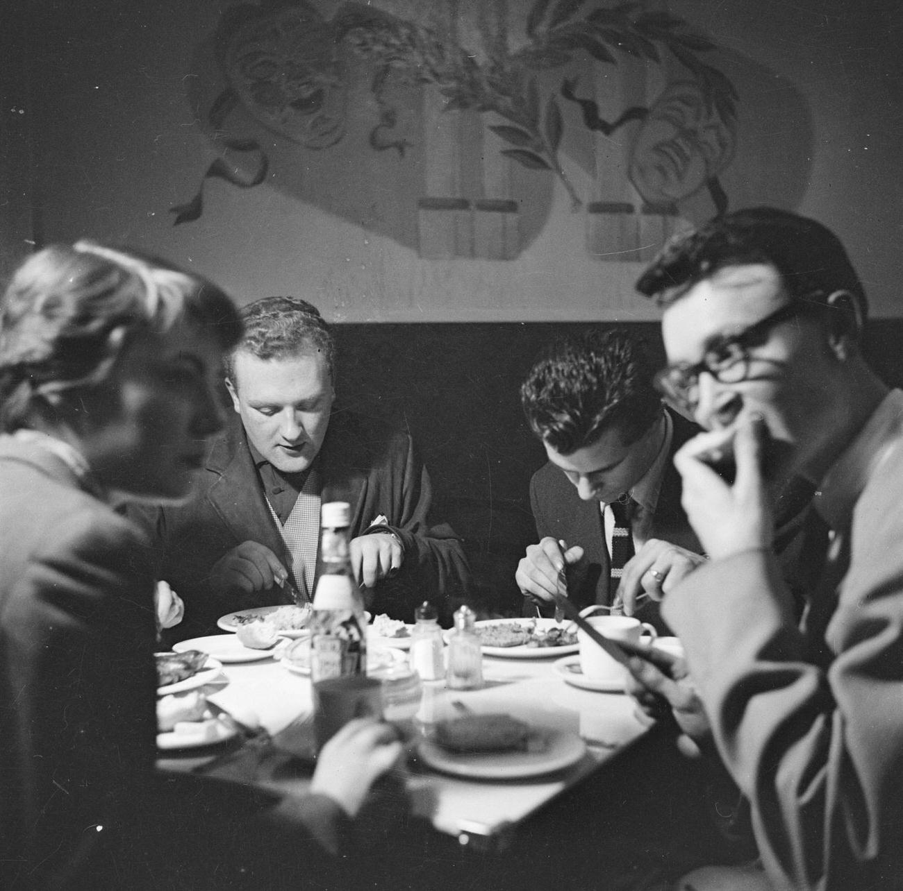 Musicians eating at the Harmony Inn by Nigel Henderson