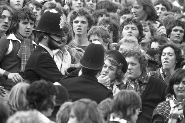 Police break up a scuffle in a crowded Loftus Road, 1970s.