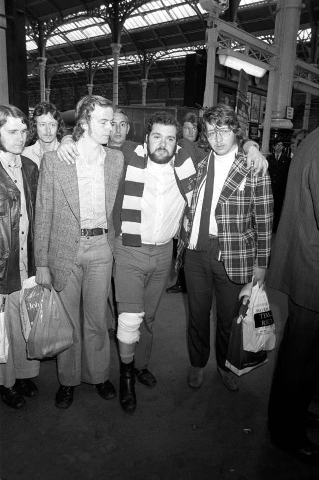 Tottenham Hotspur fan Errol Rassin is helped off the platform, 1970s.