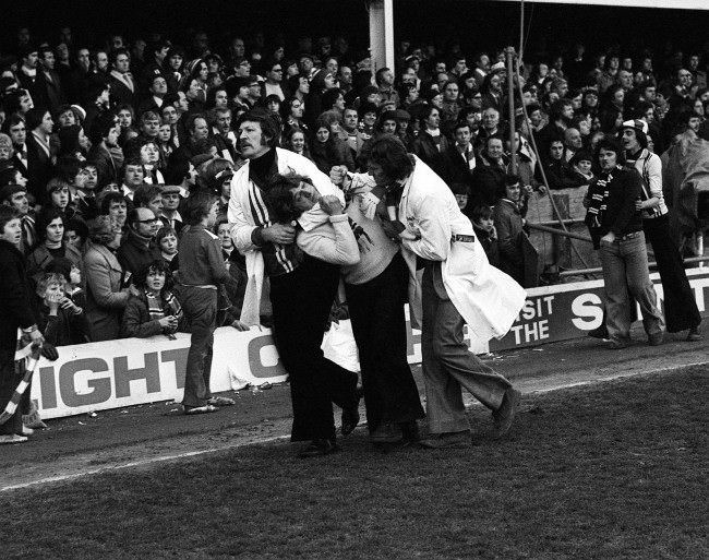 Southampton stewards ‘handling’ a fan after fights broke out, 1970s.