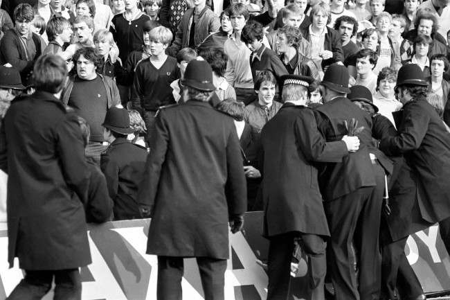 Police move in to quell crowd trouble, 1980s.