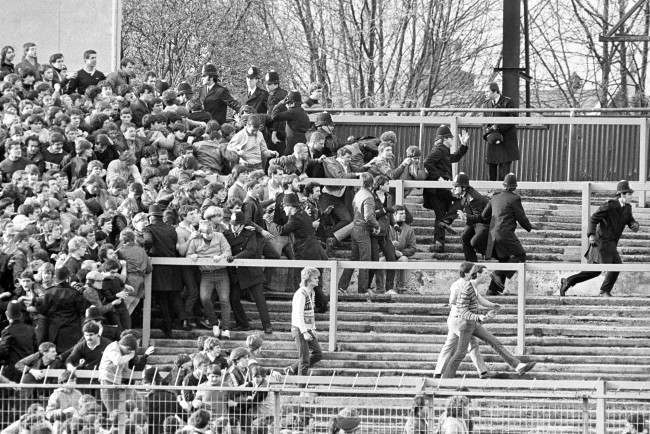 Police try to hold back Chelsea fans, 1980s.