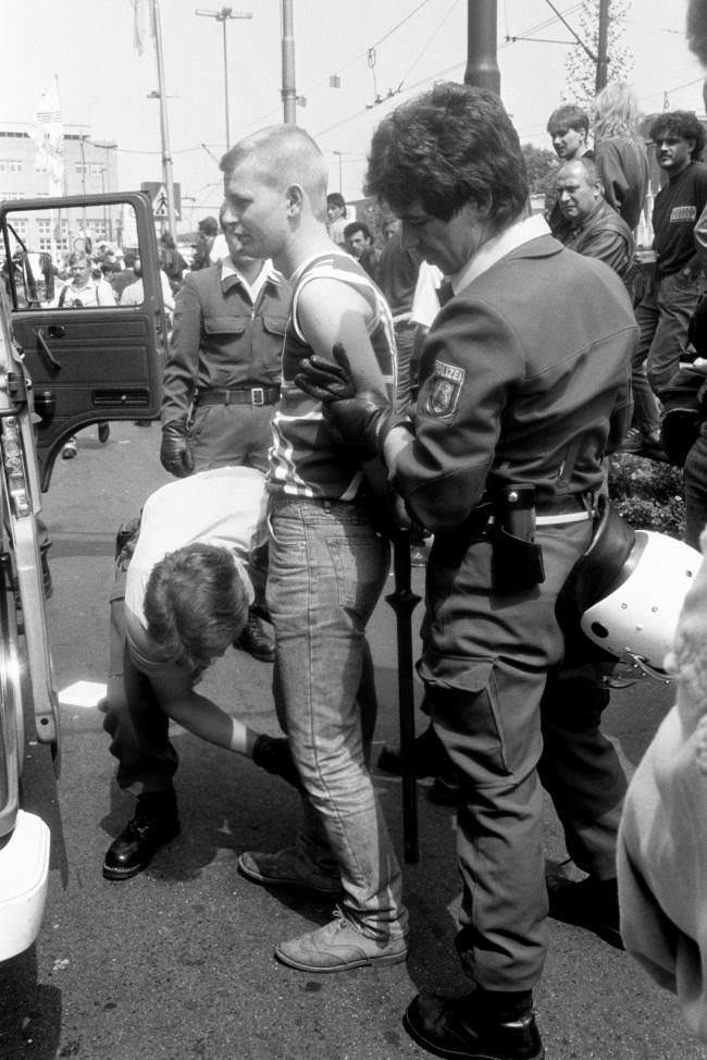 An England fan is arrested, 1980s.