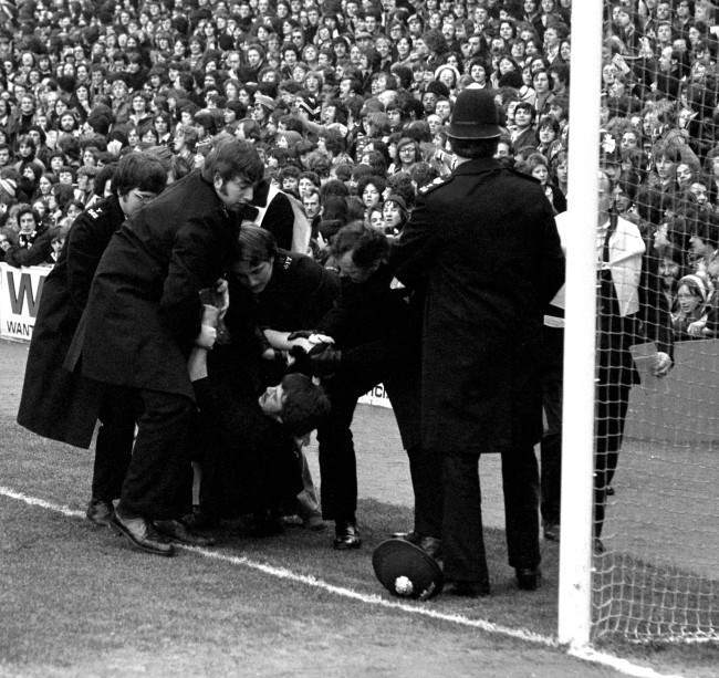 A touchline tussle, as police deal with unruly spectators, 1970s.