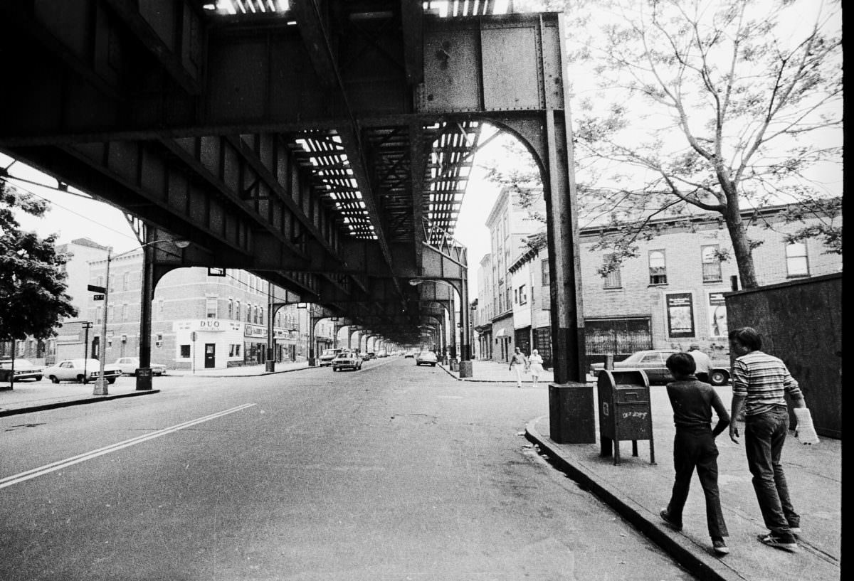 Two men walking up New Utrecht Avenue in Boro Park, Brooklyn, 1975.