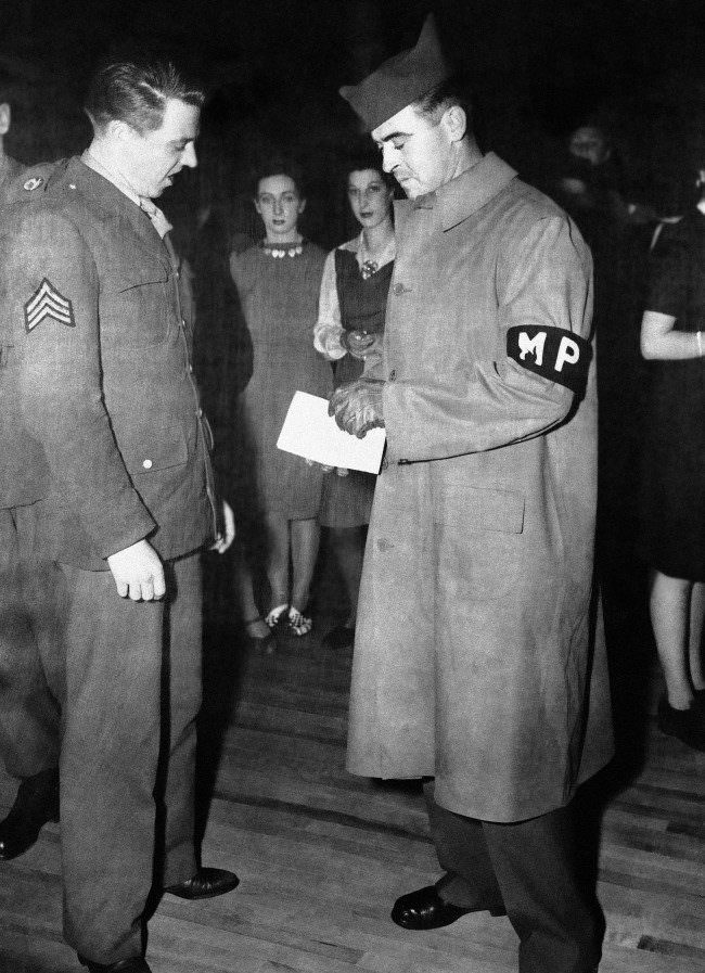 British and American police conduct a surprise survey calling for identity cards and leave permits in London, 1944.