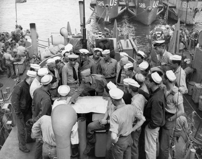 Lt. William V. Patten briefs his crew at a port in England before the invasion of France began, 1944.