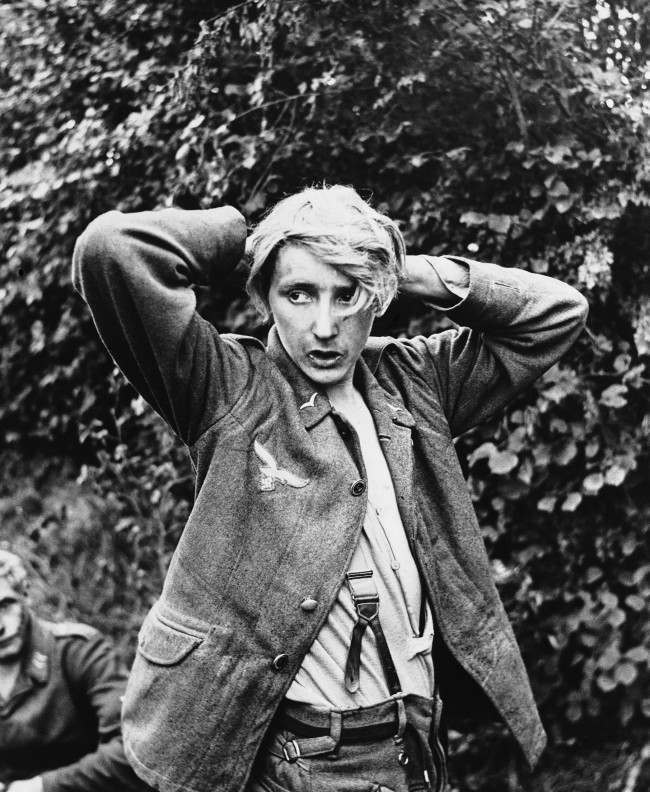 A young German soldier captured by Allied forces at St. George D’’elle in Normandy looks furtively around, 1944.