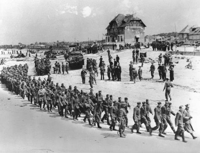 German prisoners of war, captured during the Allied Normandy invasion, are marched to the ships, 1944.