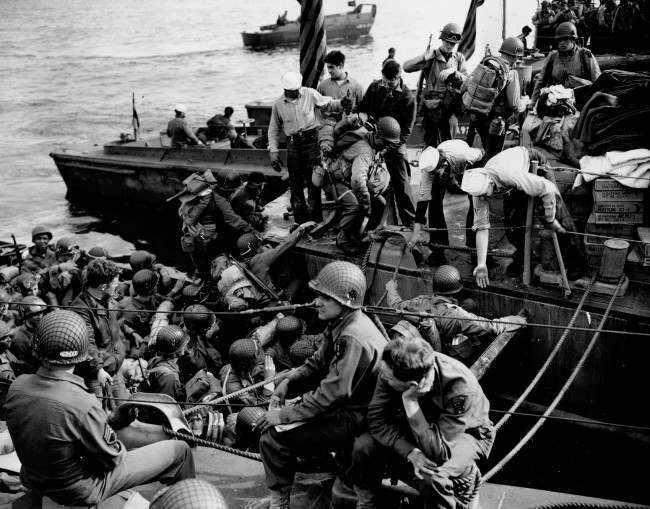 Men and supplies are being ferried out to landing crafts en route for the initial Allied invasion of the Normandy, 1944.