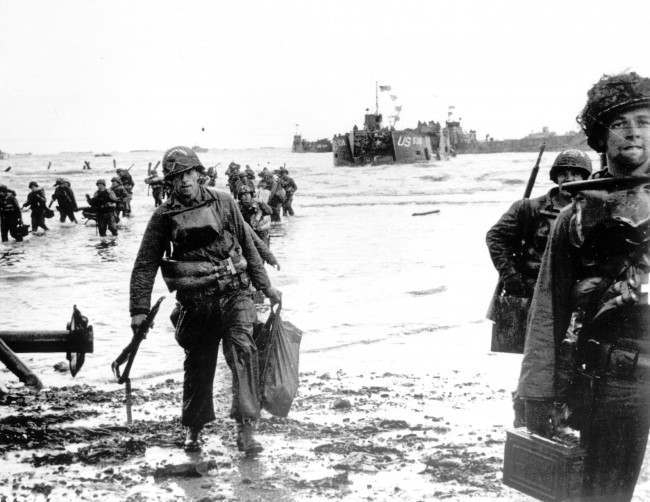 Carrying full equipment, American assault troops move onto a beachhead code-named Omaha Beach, 1944.