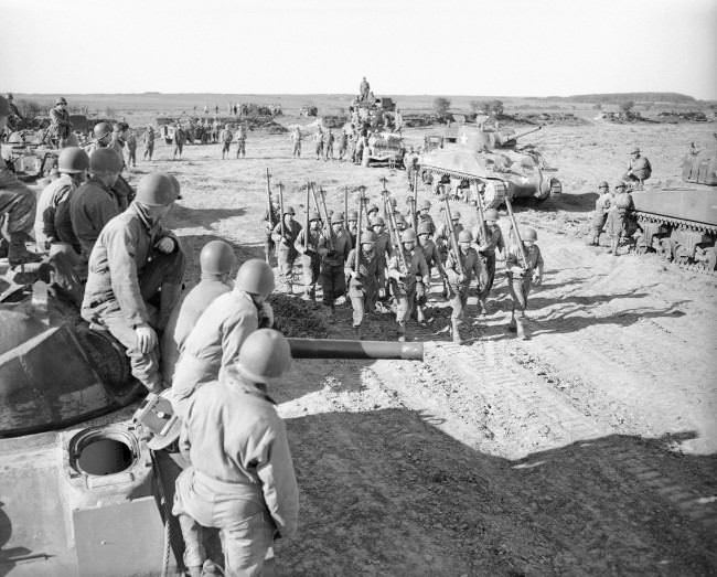 Tank maintenance men practice on a firing range in England, 1944.