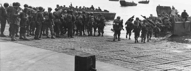 As the Allied invasion of the Normandy gets underway, American troops are shown embarking in landing crafts at a British port, 1944.