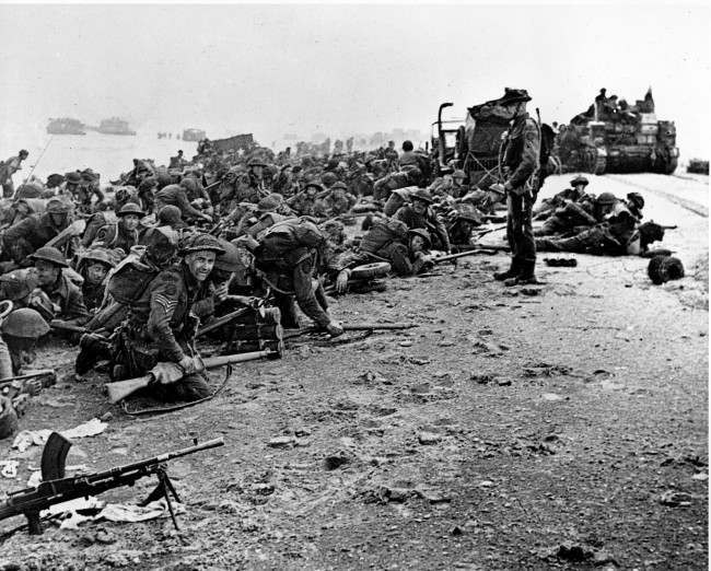 After landing at the shore, these British troops wait for the signal to move forward, 1944.