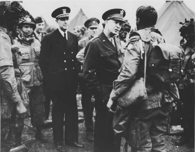 Supreme Commander Dwight Eisenhower visits paratroopers of the 101st Airborne Division at the Royal Air Force base in Greenham Common, England, 1944.