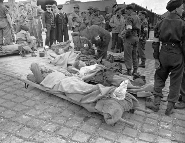 Some of the first British soldiers wounded in the French invasion coast fighting lie on stretchers, 1944.